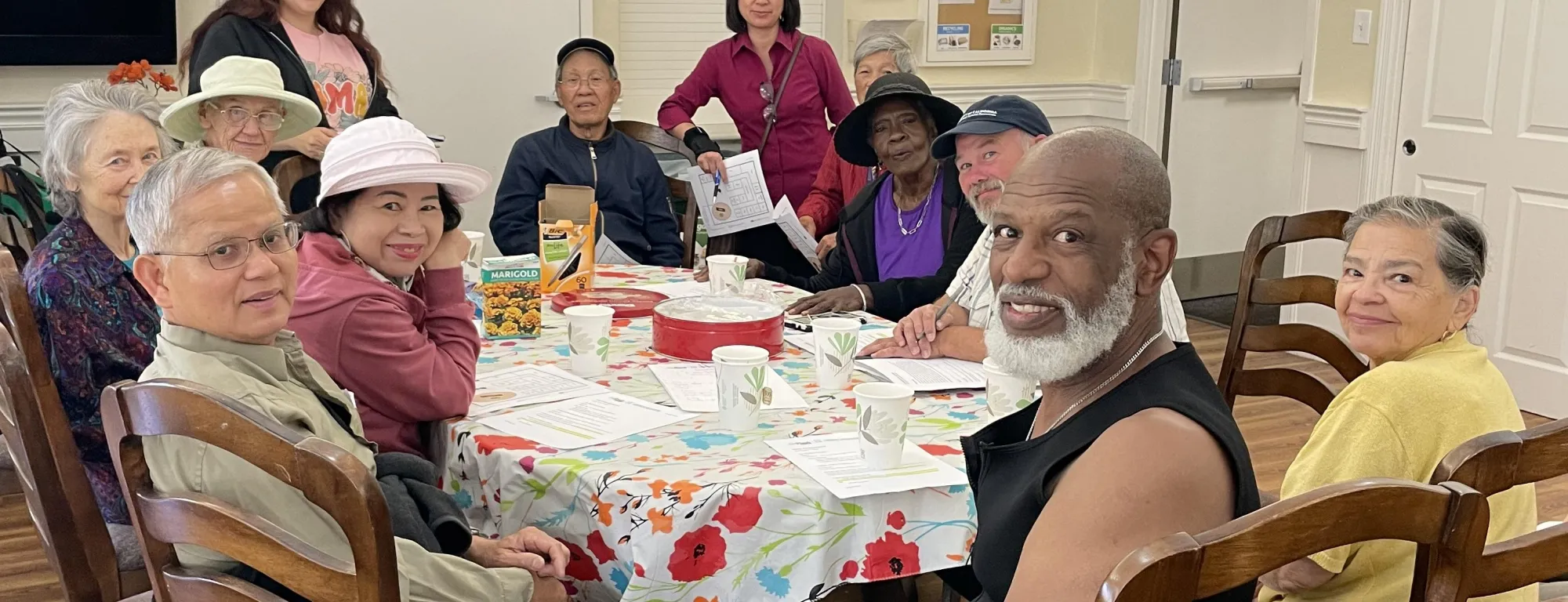Twelve people of mixed races sitting around a dining table