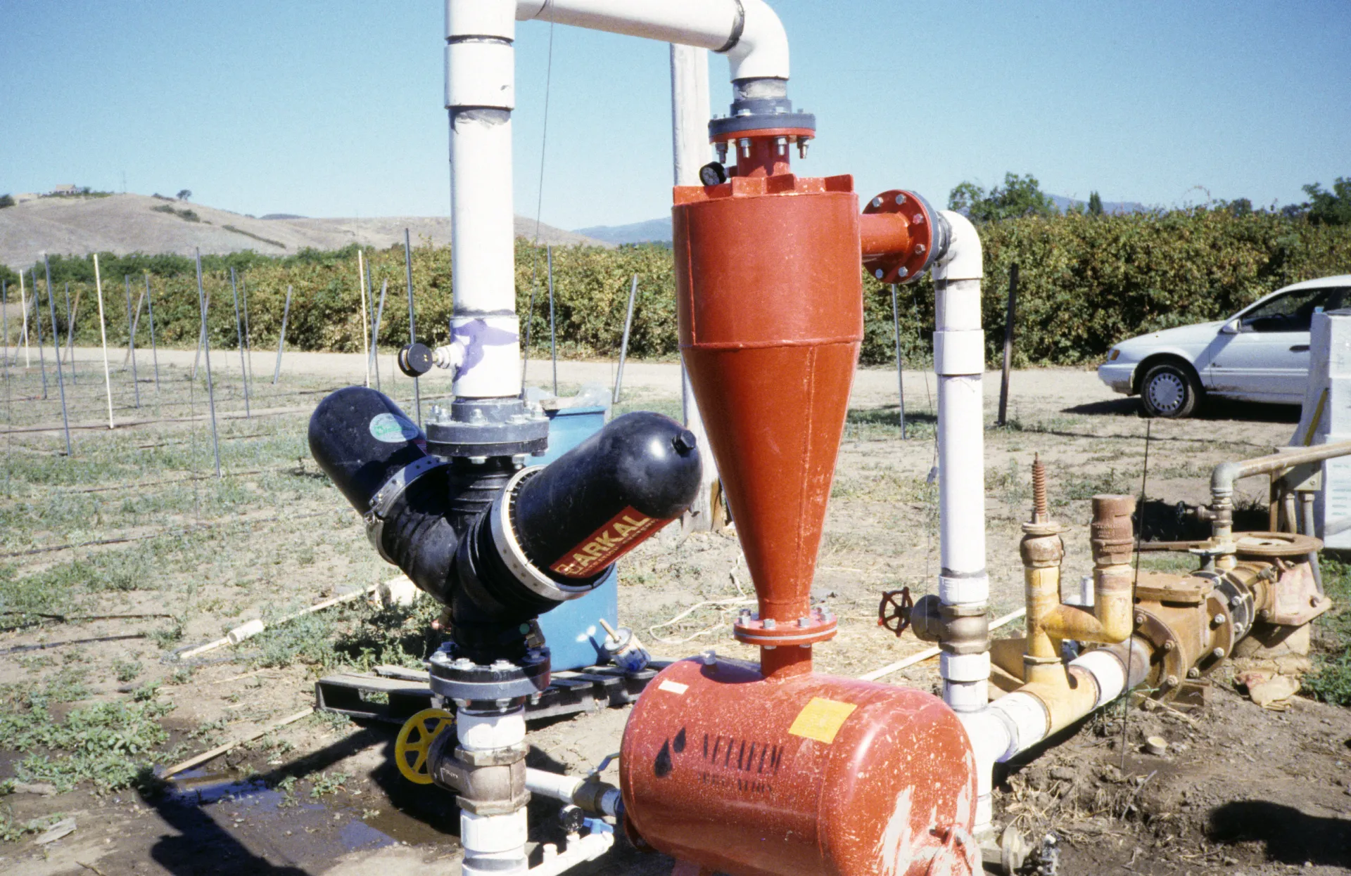 Centrifugal sand separator and disk filter on a vineyard drip irrigation system. Photo: L. Schwankl