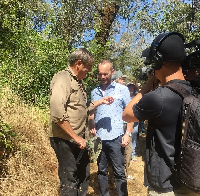 Bohart Museum of Entomology associate and dogface butterfly expert Greg Kareofelas (left) shows a California dogface butterfly to Rob Stewart of "Rob on the Road" at the Shutamul Bear River Preserve. (Photo by Fran Keller)