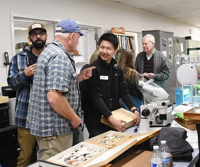 Engaged in conversations (from left) Joel Hernandez, Dick Meyer and Christopher Jason, all who received degrees from UC Davis. At far right is Jerry Powell, emeritus director of the Essig Museum. (Photo by Kathy Keatley Garvey)