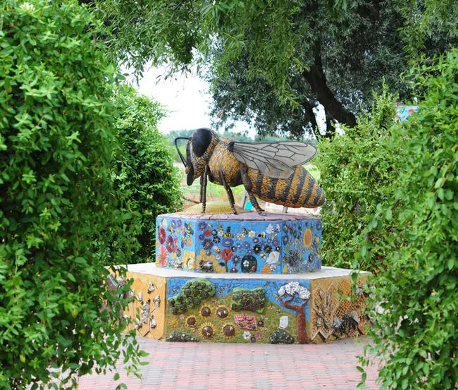 A ceramic/mosaic sculpture, "Miss Bee Haven," anchors the Häagen-Dazs Honey Bee Haven on Bee Biology Road, UC Davis. It is the work of self-described rock artist Donna Billick of Davis. (Photo by Kathy Keatley Garvey)