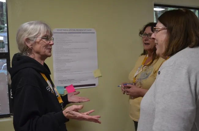 3 women talking with each other