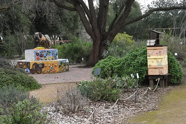 A six-foot-long worker bee sculpture, the work of Donna Billick of Davis, anchors the UC Davis Bee Haven. (Photo by Kathy Keatley Garvey)
