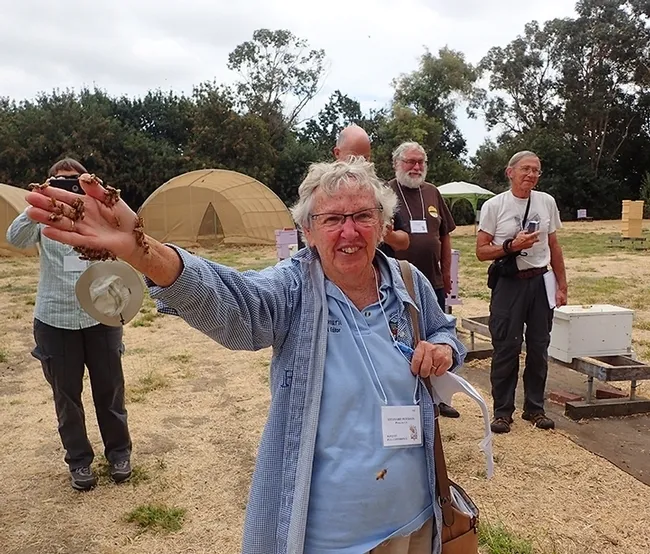 Encouraged by the workshop instructor to hold newly emerged bees, Ettamarie Peterson shows a handful of bees at the Harry H. Laidlaw Jr. Honey Bee Research Facility at UC Davis. (Photo by Kathy Keatley Garvey)