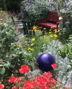 Garden bench in flower garden