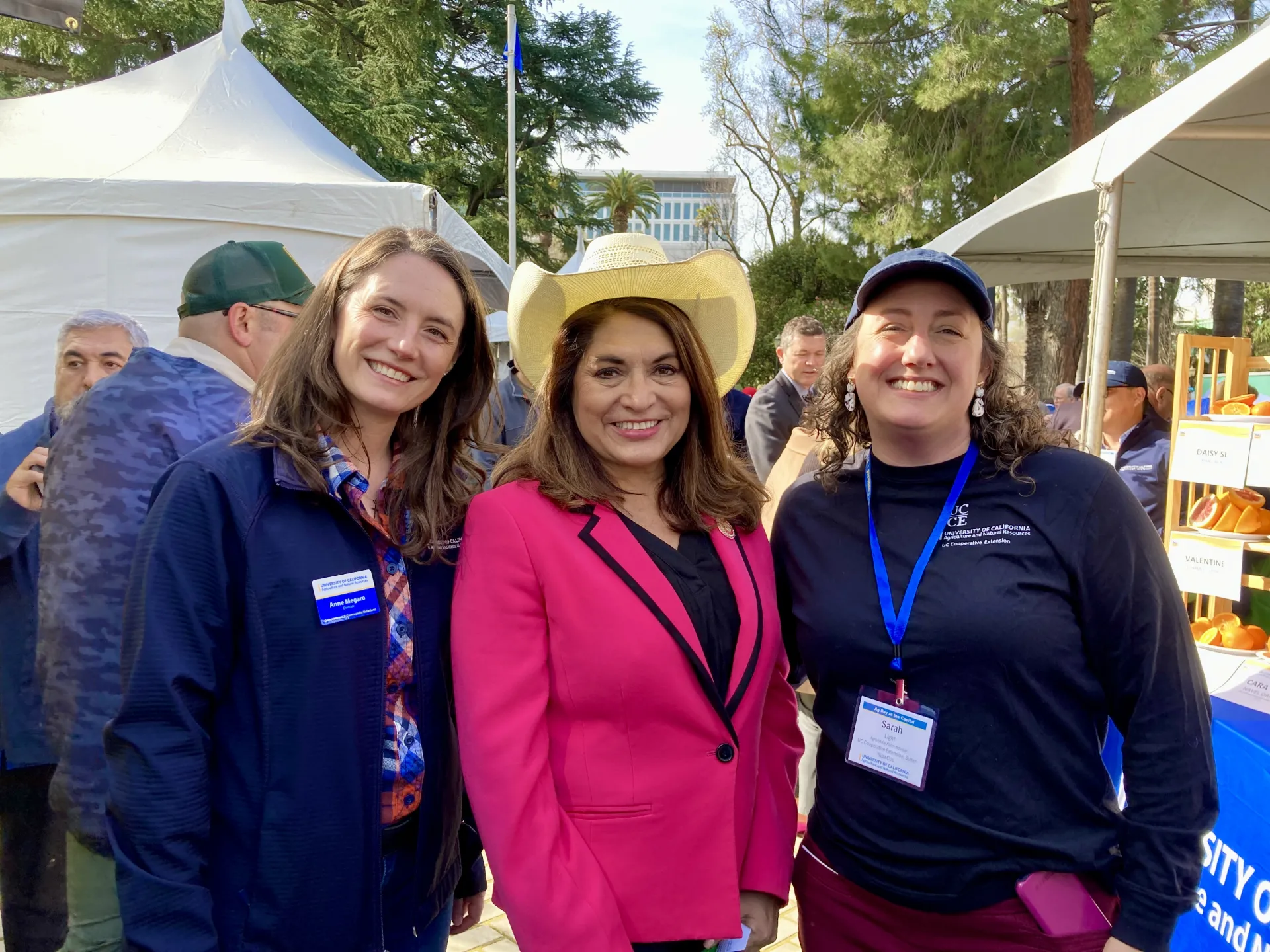 Anne Megaro, Sharon Quirk Silva who is wearing a white cowboy hat and fuchsia suit, and Sarah Light 