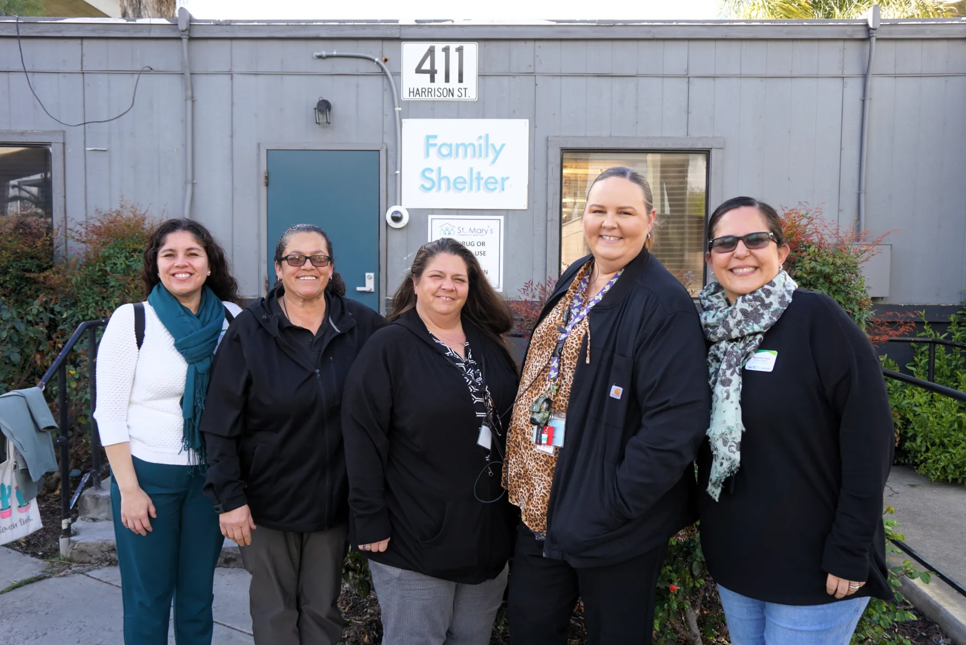 CalFresh Healthy Living, UC Cooperative Extension educators stand next to partners at St. Mary's Community Services in front of the family lodge in Stockton