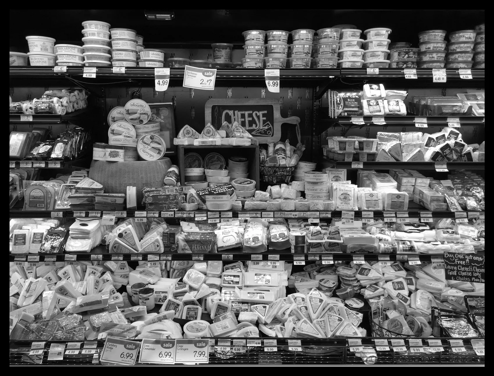 Black and white image of a grocery store cheese aisle
