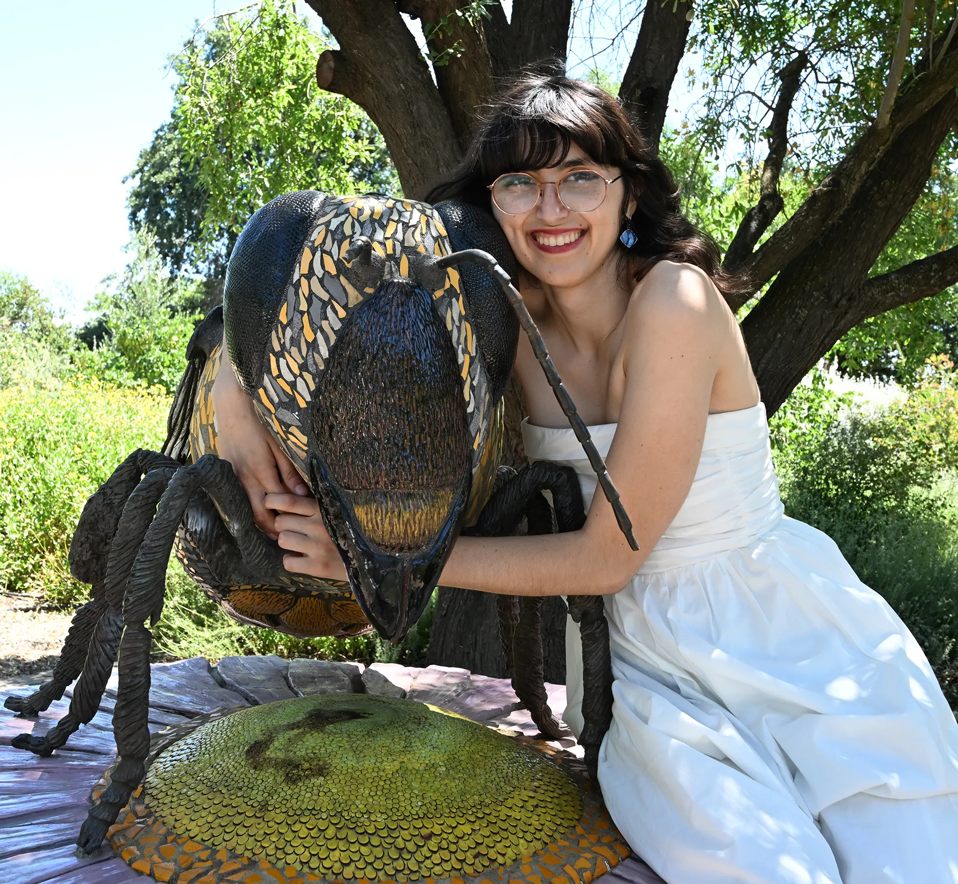 Samantha Murray and the bee sculpture in the UC Davis Bee Haven. (Photo by Kathy Keatley Garvey)