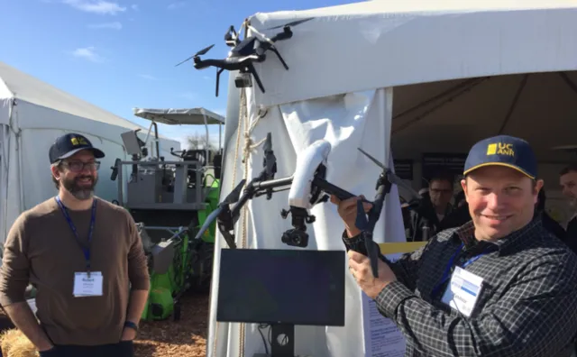 Rob Johnson, left, looks on as Sean Hogan, IGIS academic coordinator, describes the use of drones in agricultural research.