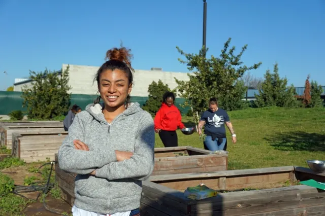 Rescue the Children resident Cecelia Williams beams proudly at the garden.