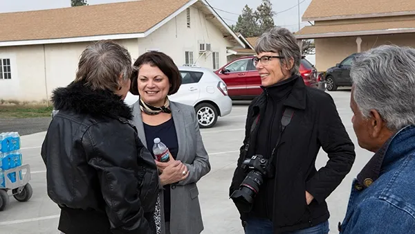 Kristine Diekman, third from left, speaks with drought relief officials in the Central Valley of California. Photo by Albert Rascon.