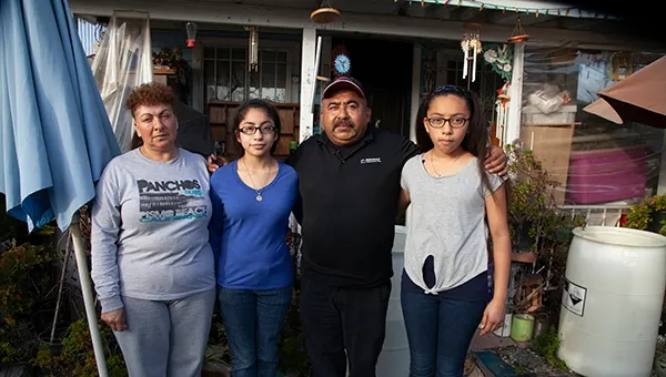 When Kristine Diekman spoke with the Garcia family, pictured in front of their home, they had been living without water in their well for almost two years. Photo by Kristine Diekman.