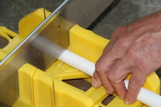 Fig. 4 Use a miter box and PVC saw to cut the bottom shaft at a 90-degree angle.