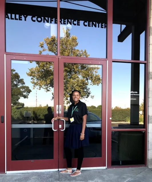 Eve outside at doorway to Valley Conference Center