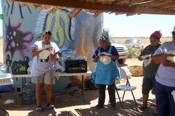 Tohono O'odham women make bread in the Sonoran desert. Photo by Angelo Baca