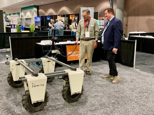 Fennimore operates handheld control to move a device that rolls on 4 wheels.