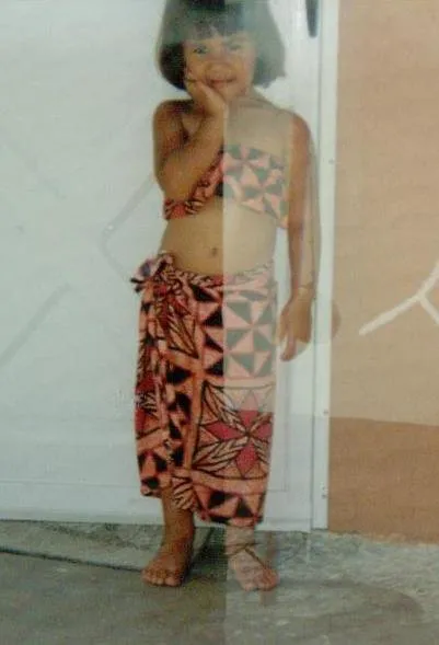 Young girl wearing a two piece outfit poses for the camera.