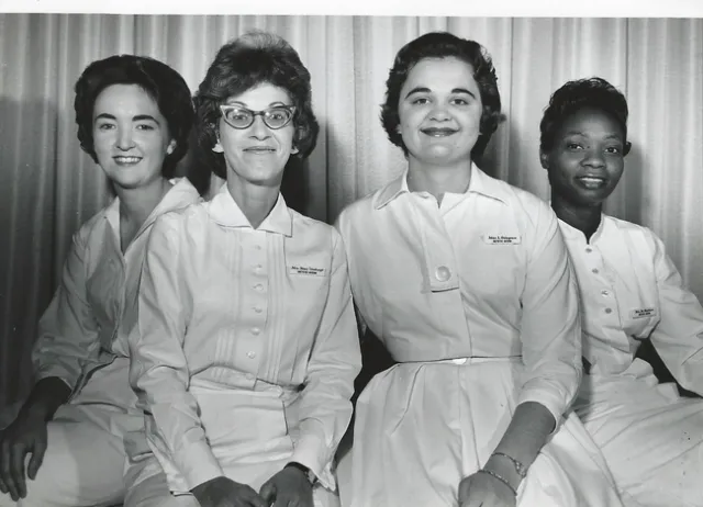 Three Caucasian women and one Black woman