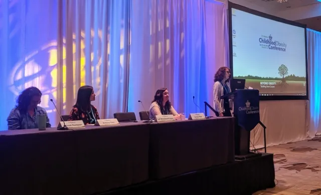 Gail Woodward-Lopez speaks at a podium at a child obesity conference