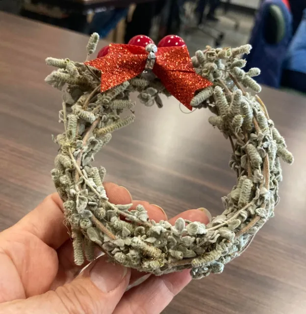 Avarado winds fresh oregano sprigs from the garden into a small wreath, then lets it dry. She adds a red bow to create a pretty and fragrant ornament.