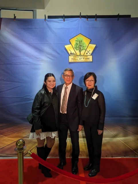 A family photo with a wife, husband and daughter.