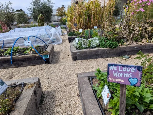 A colorful garden sign reads