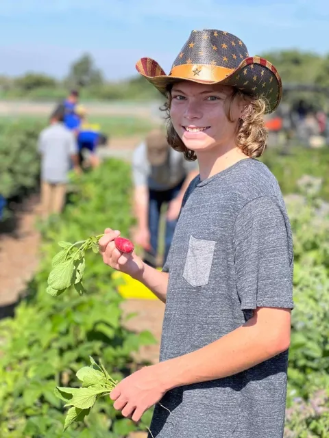 Gavin Olsen picks vegetables during a GROW field trip to South Coast REC. Photo courtesy of Gavin Olsen.