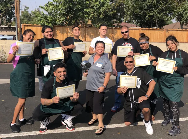 Adult EFNEP graduates proudly display their certificates of completion.
