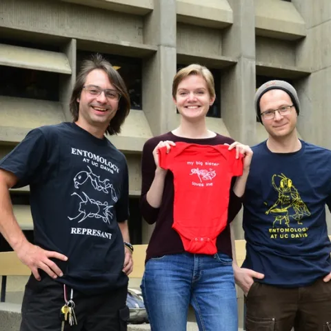 EGSA's t-shirt design winners: (from left) Brendon Boudinot wearing his t-shirt, "REPRESANT'; Jill Oberski with her onesie, "My Sister Loves Me" and Corwin Parker wearing his "BarBeeCue" t-shirt. (Photos by Kathy Keatley Garvey)