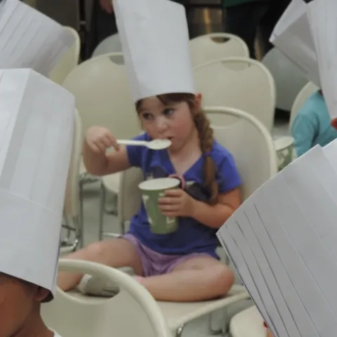Student taste testing chicken soup