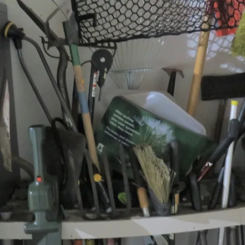 Unorganized garden tools - organize now so they are easy to find later.