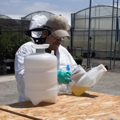 Coveralls should be worn for applications where contact with spray residue is likely. Photo by Katrina Hunter