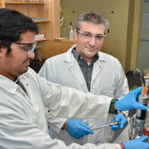 Ilias Tagkopoulos, right, in his lab at the UC Davis Genome Center with research specialist Navneet Rai in 2016. Tagkopoulos, whose work bridges computer science and biology, will lead a new institute for artificial intelligence in food systems supported by the U.S. Department of Agriculture and National Science Foundation. (UC Davis College of Engineering)
