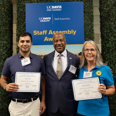The California Master Beekeeper Program, founded by UC Extension apiculturist Elina Niño, received an excellence award at the UC Davis Staff Assembly program. With Chancellor Gary May (center) are CAMBP co-program managers Wendy Mather and Kian Nikzad. Niño and Mather shared the Faculty-Staff Partnership Award. Nikzad, an integral part of the program but ineligible as a new employee to be part of the nomination, accepted the award on behalf of Niño, who was attending a conference in Chile. (Photo by Kathy K