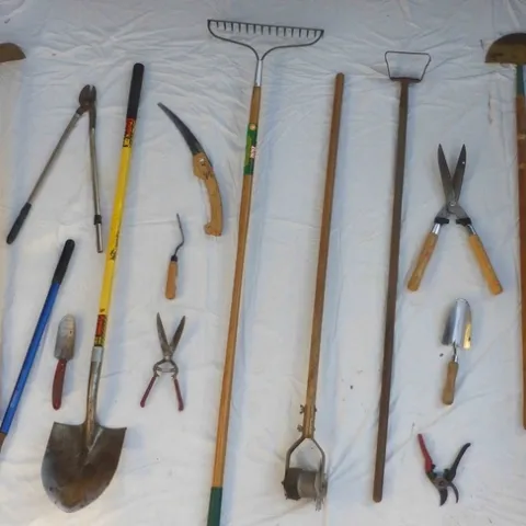Tools ready for sharpening, including pruners, hoes, rakes, and shovels.