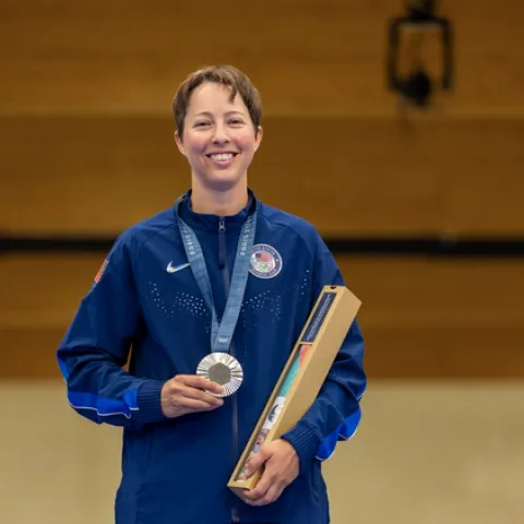 Sagen Maddalena holds the silver medal between her fingers as it hangs around her neck in Paris.