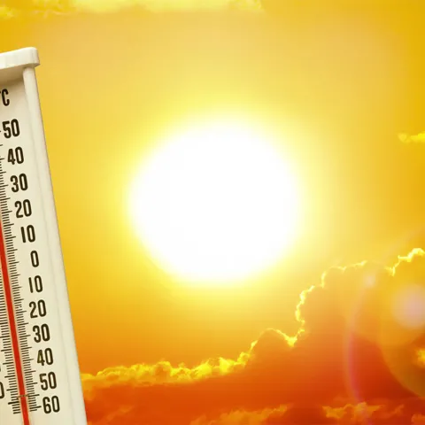yellow sky with blazing sun and thermometer in the foreground
