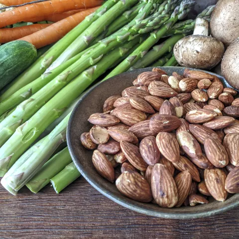 Fresh asparagus, mushrooms and almonds on a table XL