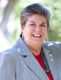 Headshot of Glenda Humiston wearing gray blazer over a red top.