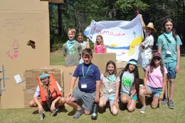 Campers at Resident Camp posing in front of their fort