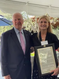 Oberholster holds a framed statement titled