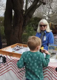 Chris Casey, the manager of the UC Davis Bee Haven, talks to a youngster at an open house. (Photo by Kathy Keatley Garvey)