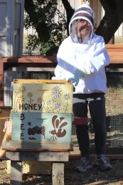Connie inspects our bee hive
