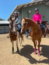 Two 4-H youth members riding on horses