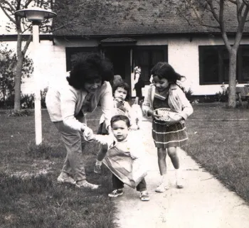 In this childhood photo, mother Lilia Galvan holds her daughter, Elvira. Elvira's siblings Virginia