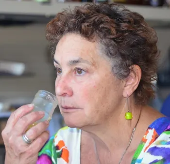 Amina Harris in process of taste-testing honey (Photo by Kathy Keatley Garvey)