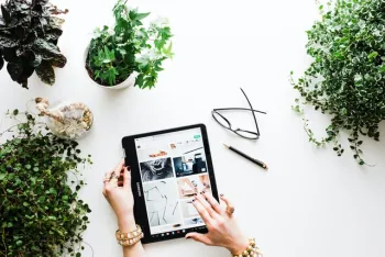 Person using black tablet with plants (Photo: Brooke Lark)