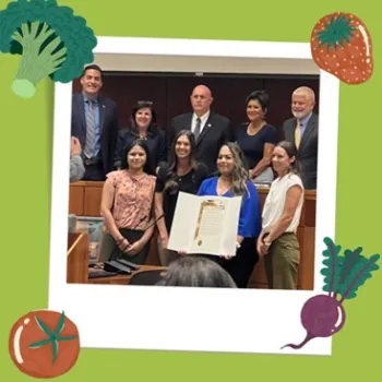5 County Board of Supervisors and 4 UCCE staff standing and holding the proclamation