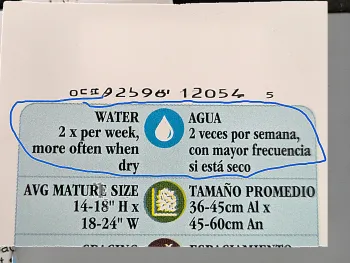 A plant label with the watering needs highlighted